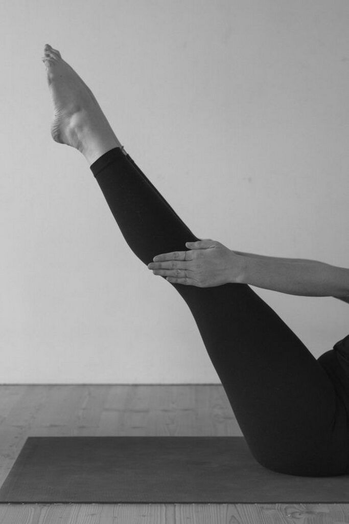 a woman is doing yoga on the floor