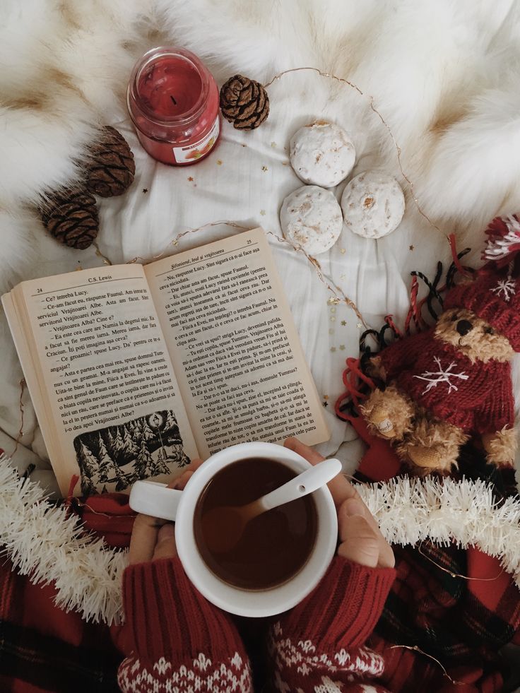 a person is reading a book and drinking coffee