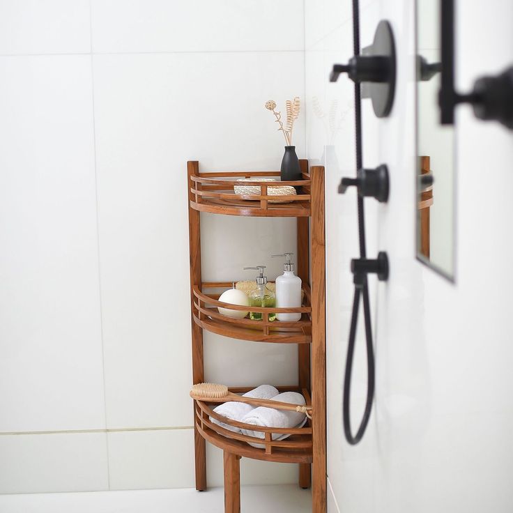 a bathroom with a wooden shelf next to the shower