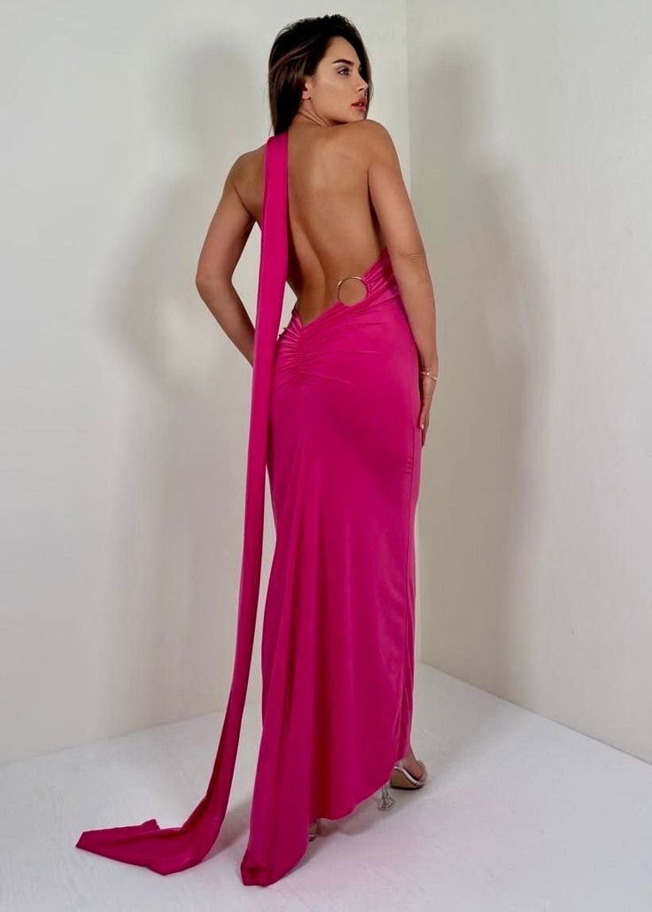 a woman in a pink dress is standing back to back with her hands on her hips