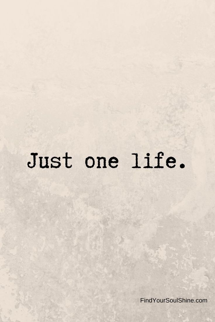 the words just one life are written in black ink on a white concrete background with an aged