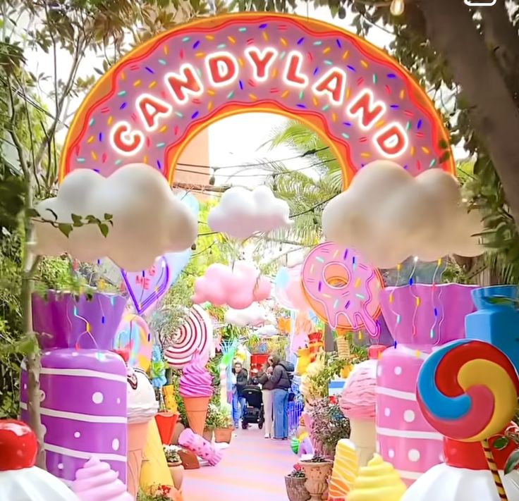 the entrance to candy land is decorated in pink, yellow and blue