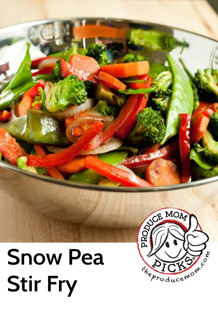 a bowl filled with stir fry vegetables on top of a wooden table