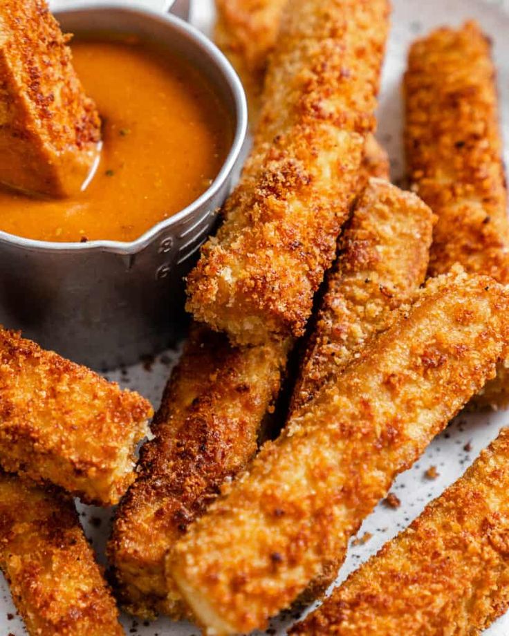 fried fish sticks with dipping sauce on the side