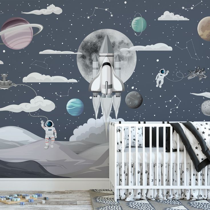 a baby's room with space themed wallpaper