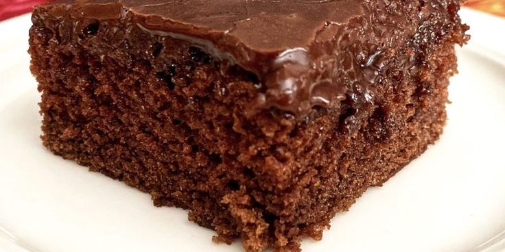 a piece of chocolate cake sitting on top of a white plate