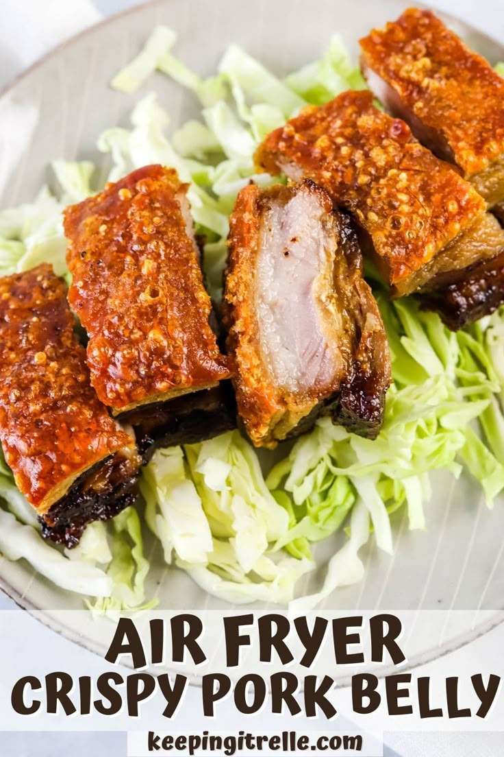 an air fryer crispy pork belly on a bed of lettuce with sauce