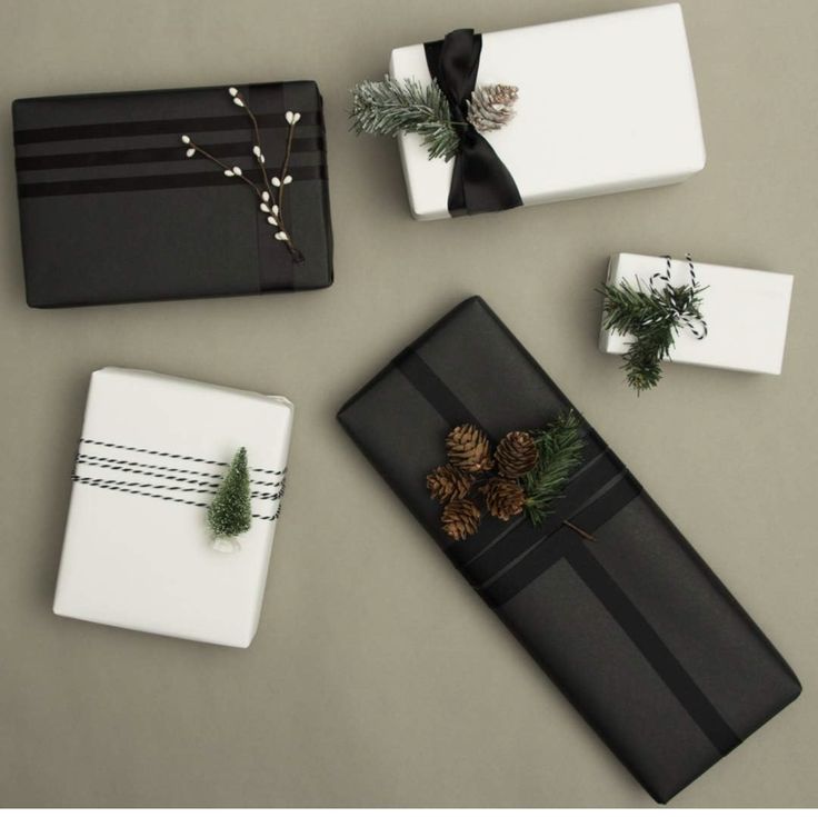 presents wrapped in black and white paper with pine cones