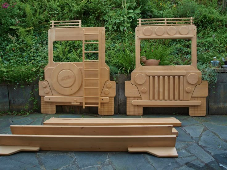 two wooden jeeps sitting next to each other