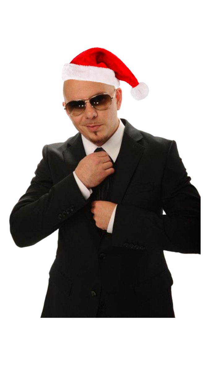 a man in a suit and santa hat with sunglasses on his head is adjusting his tie