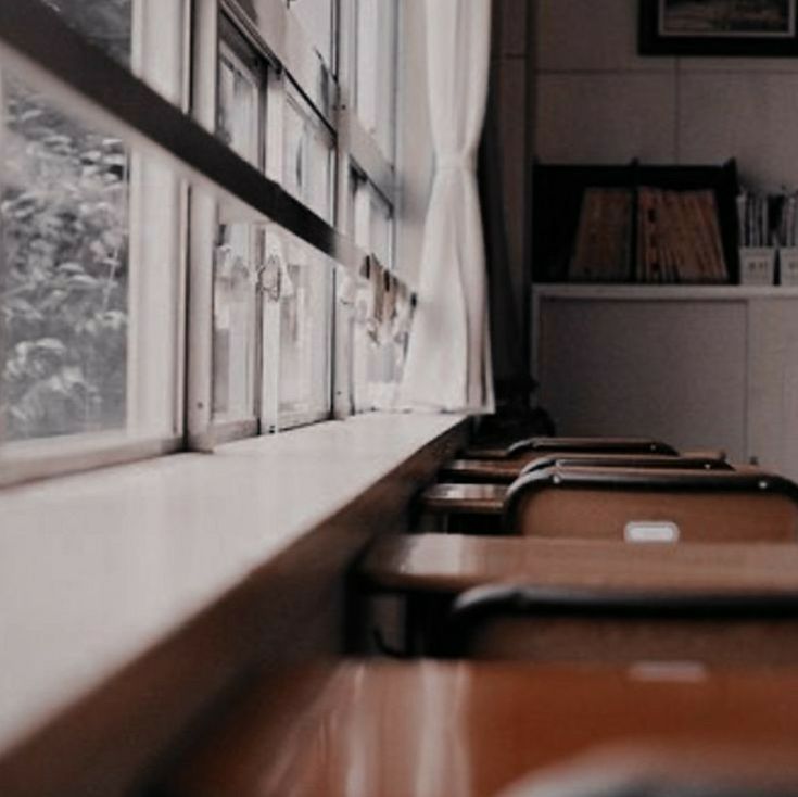 a row of chairs sitting next to a window