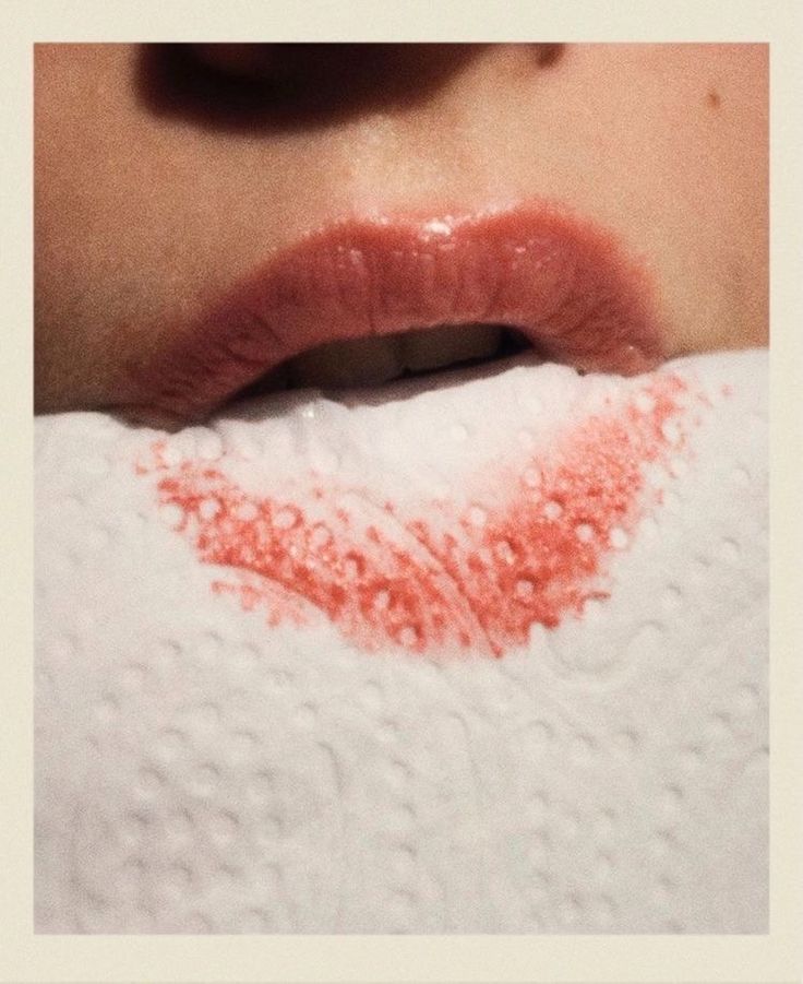 a woman's lips are covered in red crayons and white knits