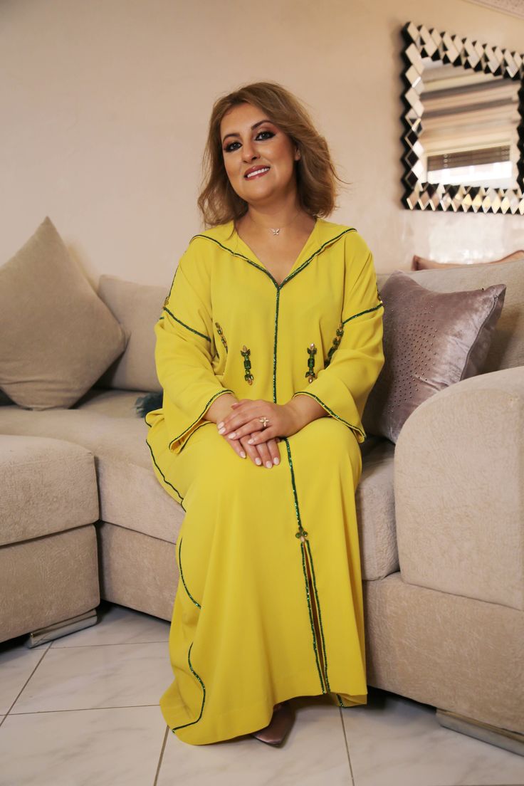 a woman sitting on top of a couch in a living room