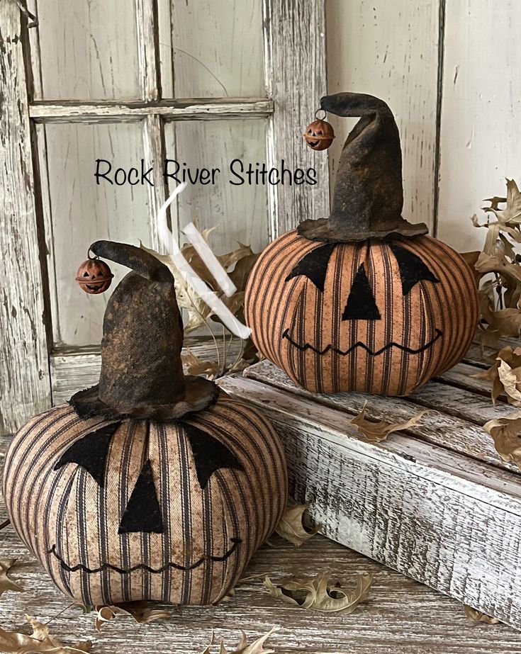 two pumpkins with jack - o'- lantern faces painted on them are sitting next to each other