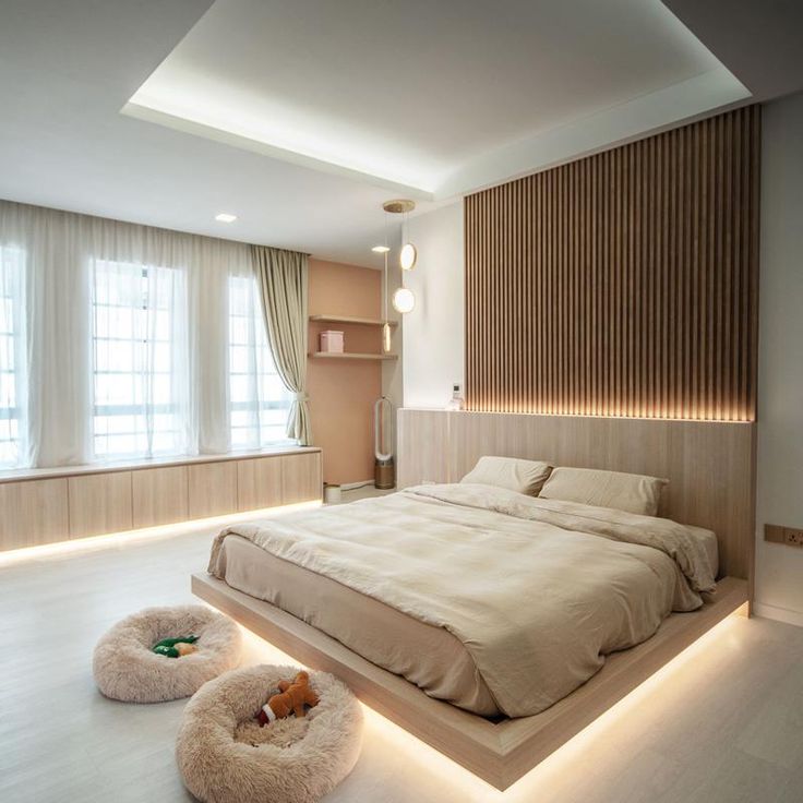 a large bed sitting in the middle of a bedroom next to two round lights on either side of it