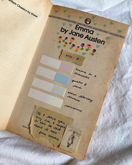 an open book with torn paper and stickers on the pages that read by jane austen