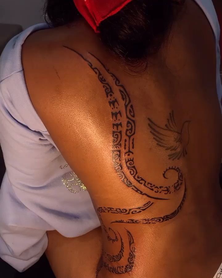 a woman with a tattoo on her back