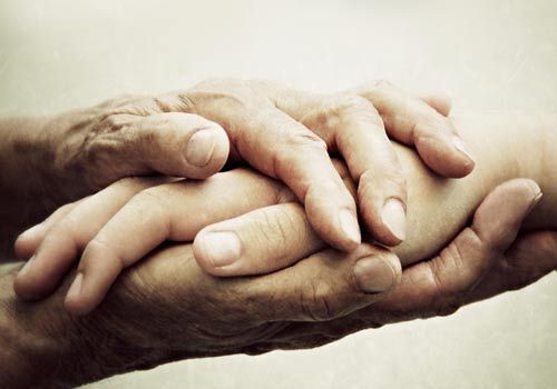 two people holding each other's hands with the words written in different languages behind them