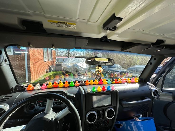 the interior of a car is decorated with gummy bears and other decorations on the dash board