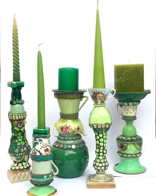 a group of vases with candles in them