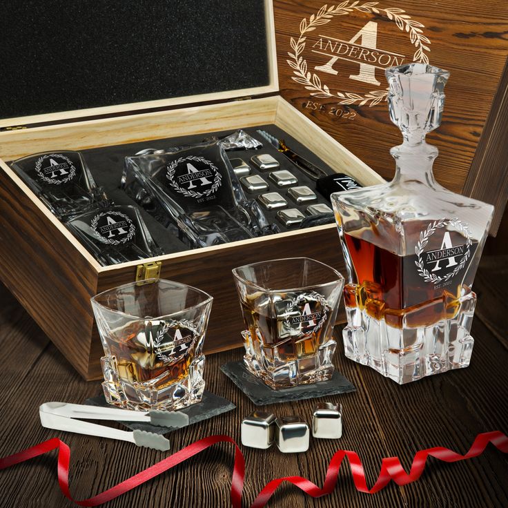 an assortment of whiskey glasses in a wooden box