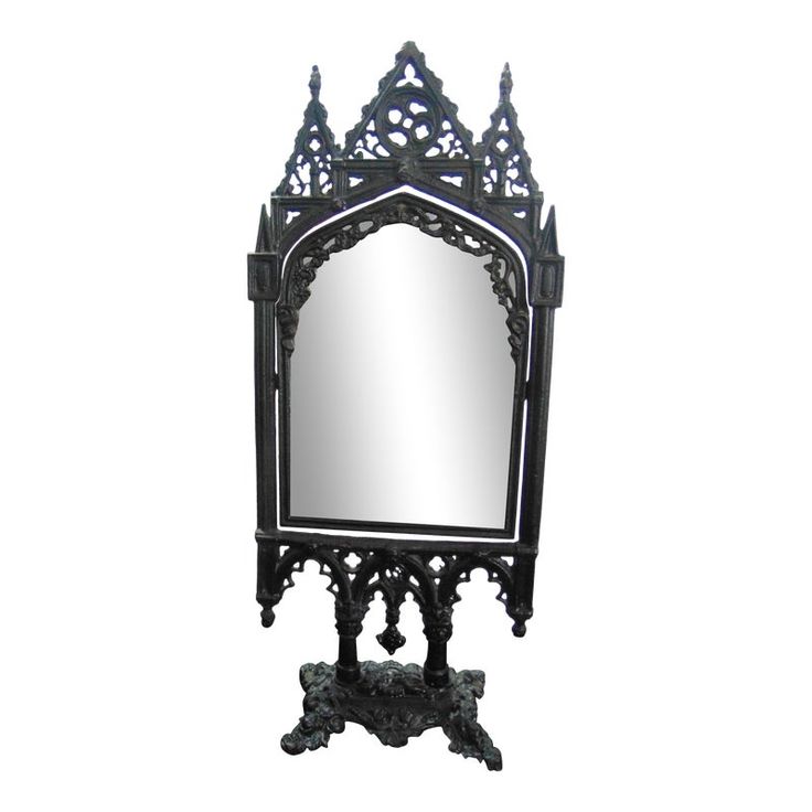 an ornately designed mirror is shown against a white background with the reflection of it's own