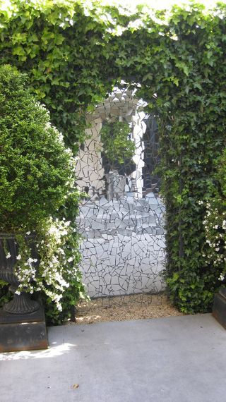 an outdoor area with plants and stone walls