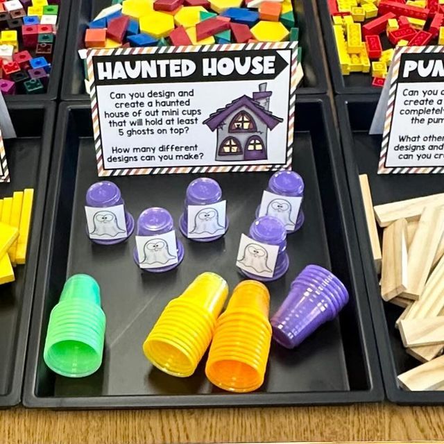 three trays filled with different colored plastic blocks and some sort of building block toys