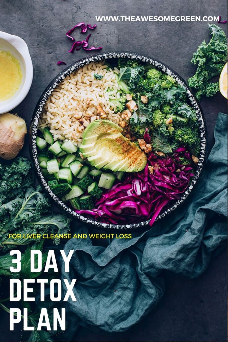 a bowl filled with rice, broccoli and other vegetables next to lemons