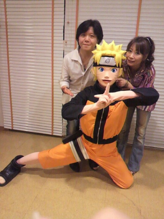 three people posing for a photo with naruto