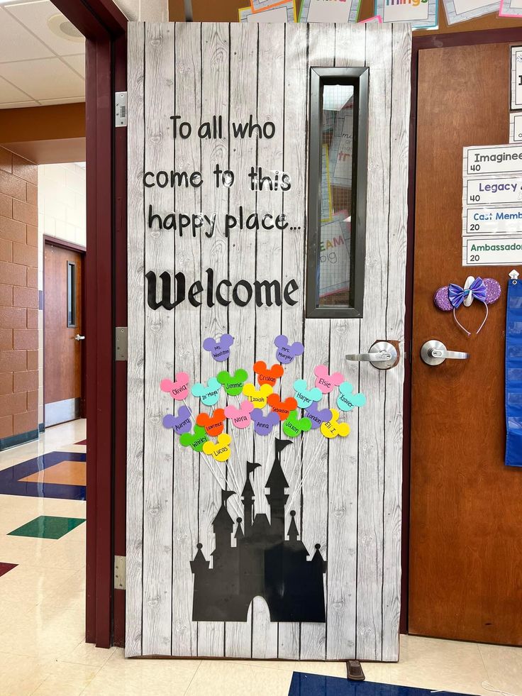 a door decorated with paper flowers and the words welcome to all who come in this happy place