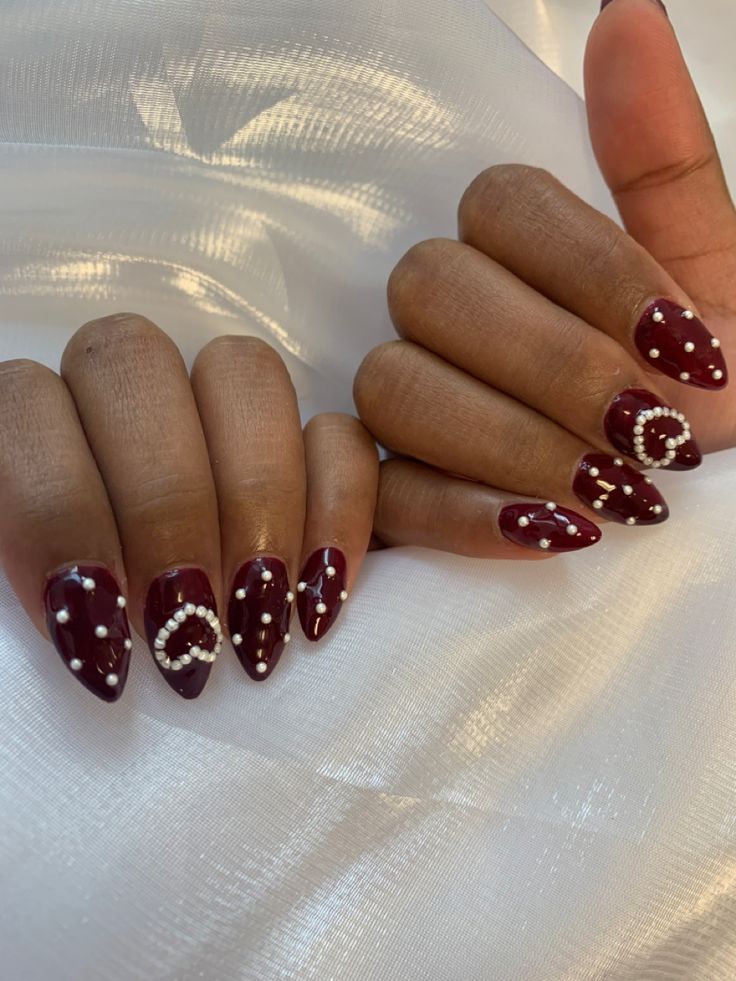 Red Nails With Pearls On Them, Burgundy Nails With Pearls, Dark Vday Nails, Dark Red Nails With Pearls, Dark Red Pearl Nails, Red With Pearls Nails, Red Nails Pearls, Red And Pearl Nails, Red Nails With Stones