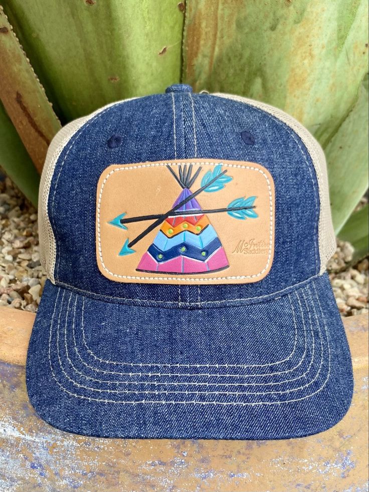 Ladies Cap Denim/Tan/Purple/Blue Tan Mesh Back Hand Tooled & Painted Leather Teepee Patch Casual Purple Baseball Cap With Curved Bill, Multicolor Casual Trucker Hat With Curved Bill, Casual Multicolor Trucker Hat With Curved Bill, Casual Brown Snapback Hat For Spring, Casual Adjustable Purple Hat, Casual Purple Cap, Casual Outdoor Baseball Cap With Leather Patch, Purple Adjustable Trucker Hat, Casual Purple Adjustable Trucker Hat