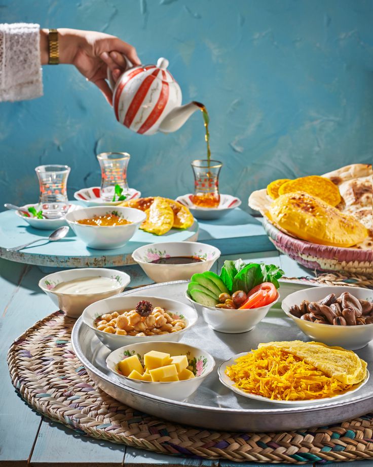 a table filled with plates and bowls full of food