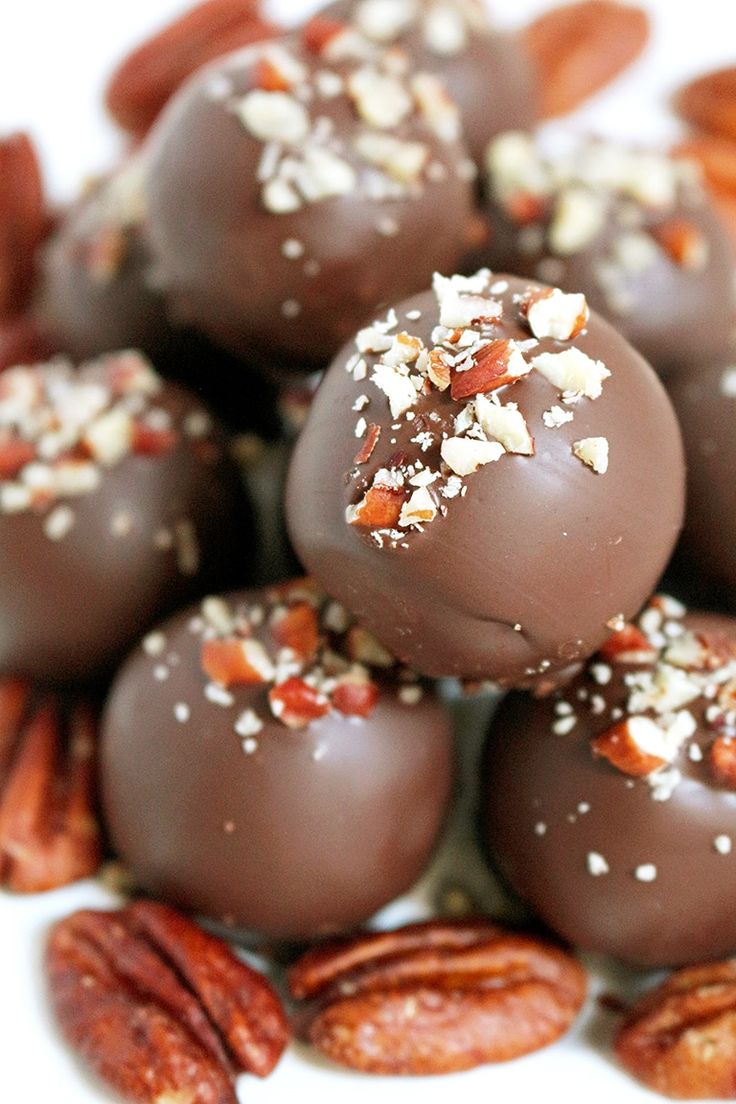 chocolate covered candies with nuts and pecans around them