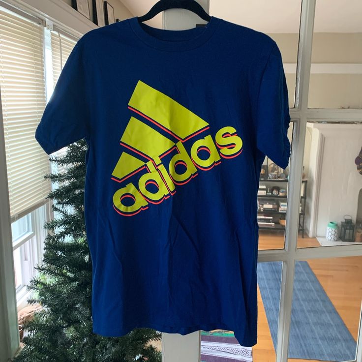 Adidas Blue T-Shirt W/Day Glo Font Size M Never Worn W/Tag Smoke/Pet Free Home In Mint/Excellent/Flawless Condition Wrinkles Will Be Ironed Out On Tumble Dry Blue Adidas T-shirt With Logo, Blue Sports T-shirt With Text Print, Blue Adidas Logo Cotton Top, Blue Cotton Adidas Logo Tops, Blue Graphic Tee With Logo Print, Blue Sporty Adidas Logo T-shirt, Blue Sports T-shirt For Summer, Sporty Blue Adidas Logo T-shirt, Casual Blue Adidas Logo Top