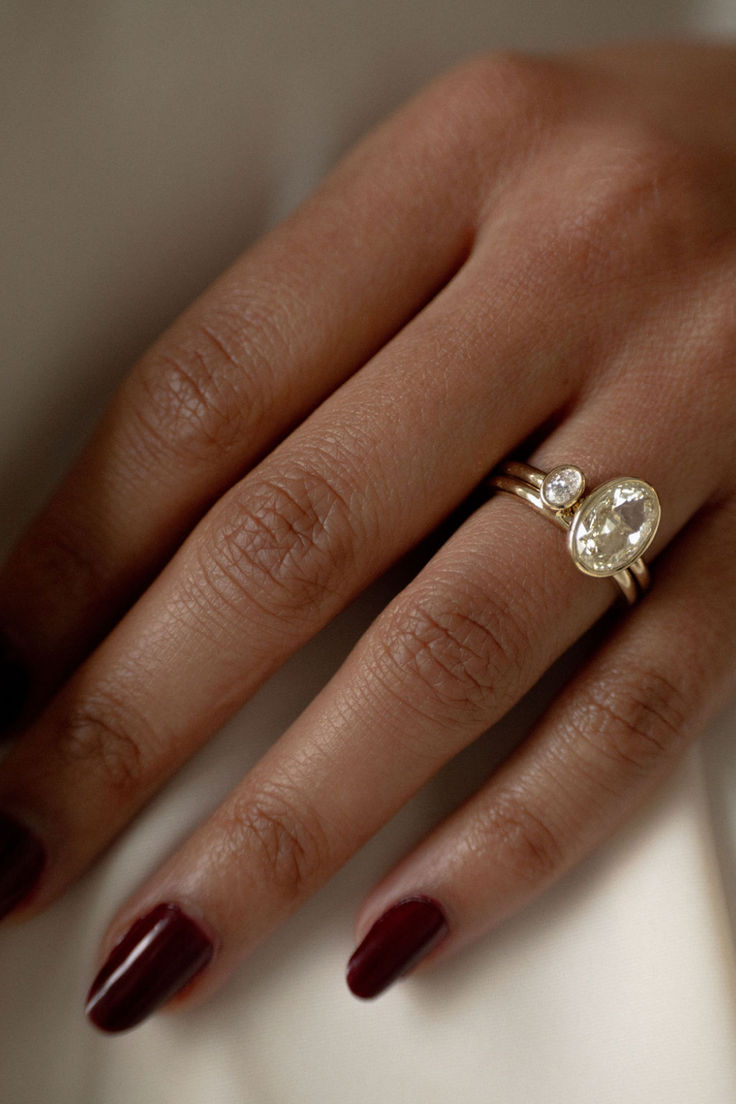 a woman's hand with a ring on it