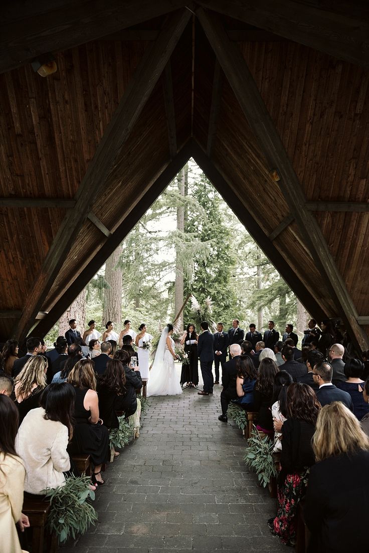 a bride and groom are walking down the aisle