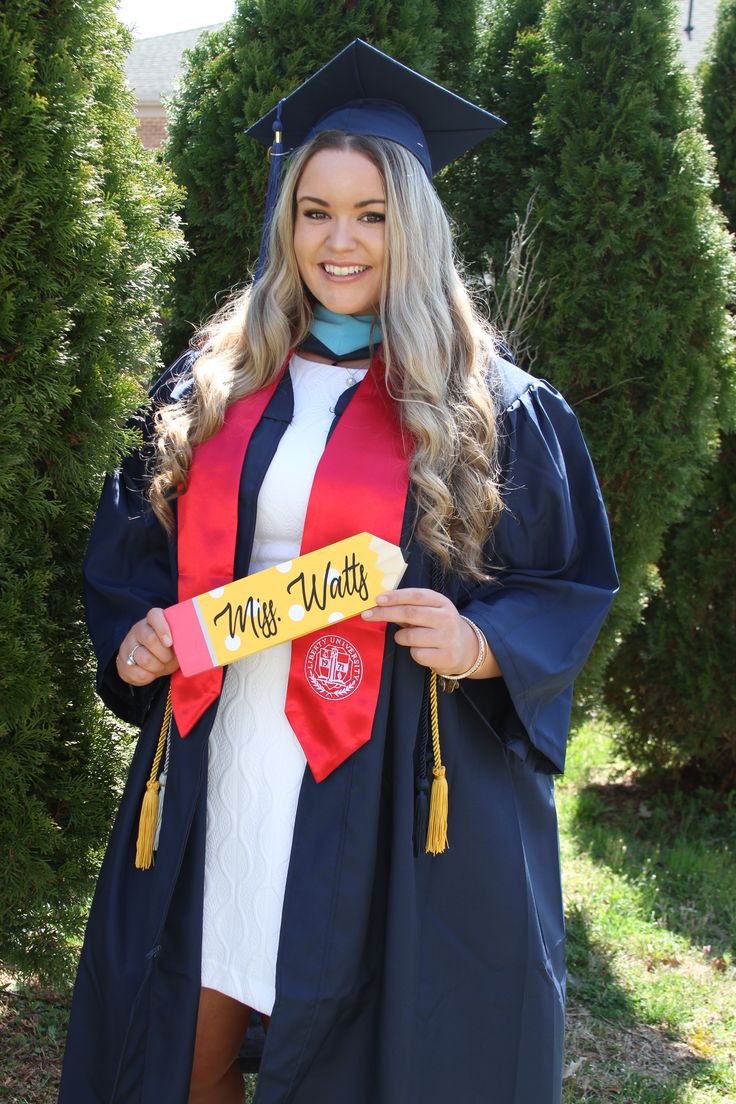 a woman wearing a graduation gown and holding a diploma