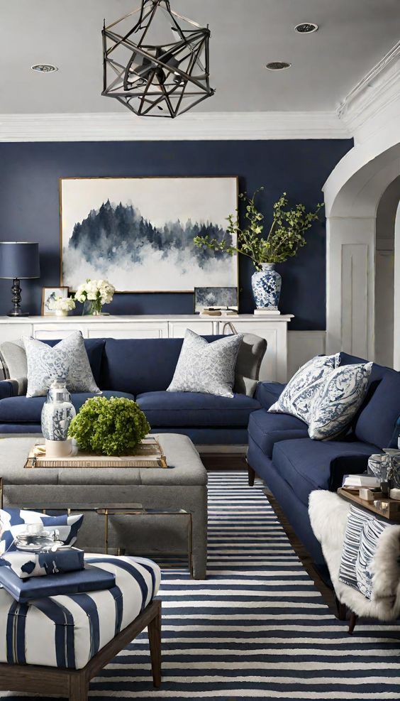 a blue and white living room with striped rugs on the floor, two couches in front of a coffee table