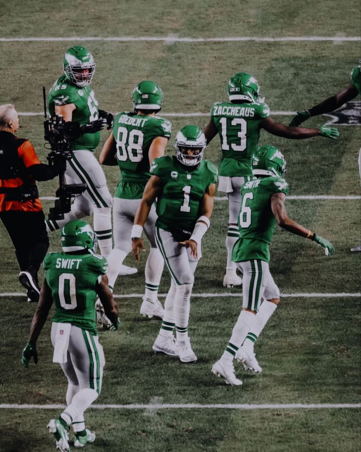 a group of football players standing on top of a field