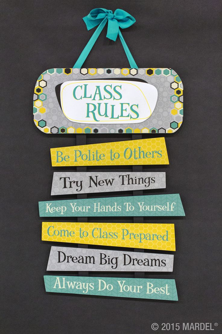 a sign that says class rules hanging on the wall in front of a chalkboard