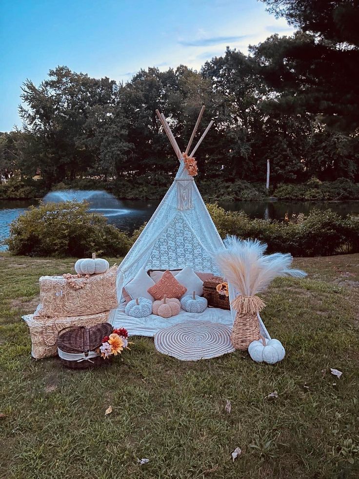 a teepee sitting on top of a lush green field