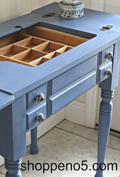 a blue desk with drawers on the top