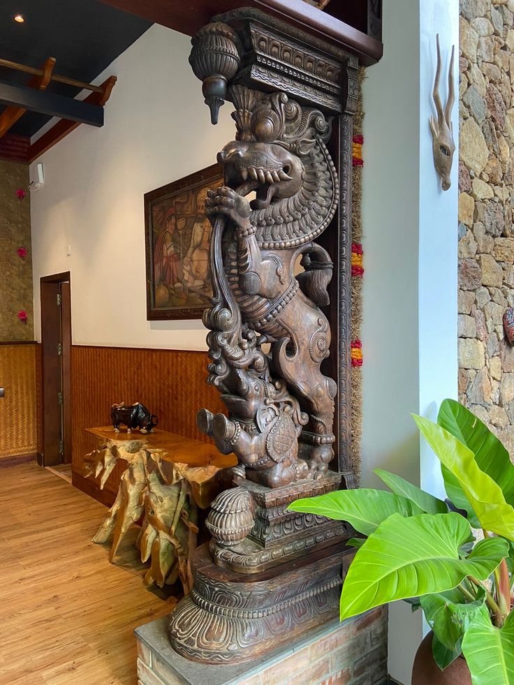 an ornate wooden sculpture in the middle of a room