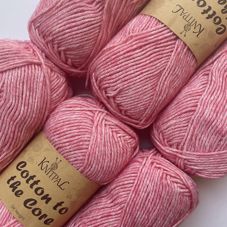 three skeins of pink yarn on a white surface with the words cotton to wool written in gold