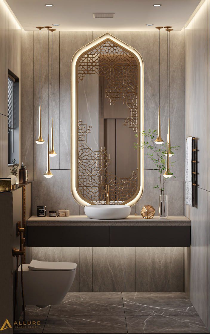 a bathroom with a sink, mirror and lights on the wall next to the toilet