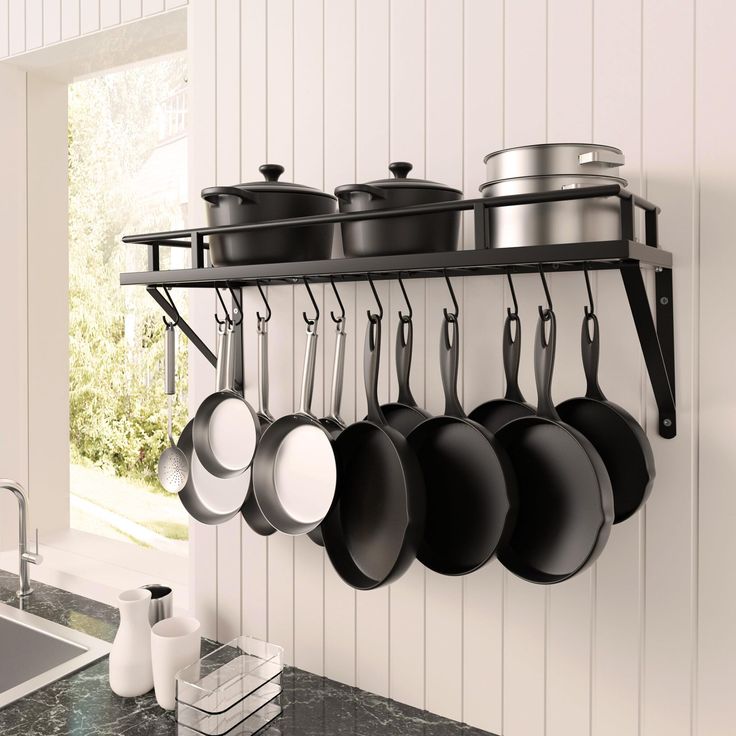 pots and pans are hanging on the wall