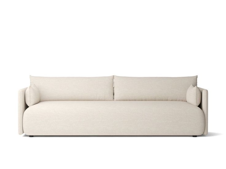 a white couch with two pillows on it