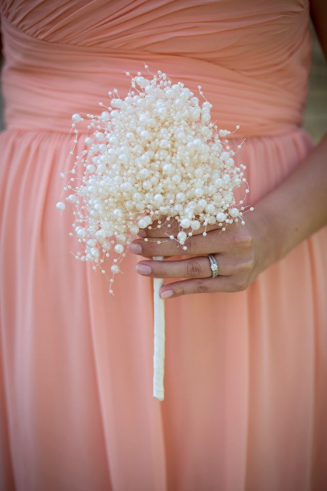 a bridesmaid holding a bouquet of baby's breath